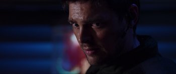 Movie still from “Doom” (2005), directed by Andrzej Bartkowiak – A man's face in the dark; Close Up shot, Over the shoulder angle