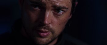 Movie still from “Doom” (2005), directed by Andrzej Bartkowiak – A man's face with a dark background; Extreme Close Up shot, Over the shoulder angle