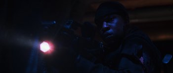 Movie still from “Doom” (2005), directed by Andrzej Bartkowiak – A man with a gun in a dark room; Close Up shot, Low angle