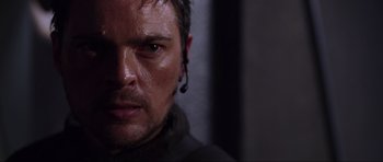 Movie still from “Doom” (2005), directed by Andrzej Bartkowiak – A man's face in the dark; Close Up shot, Over the shoulder angle