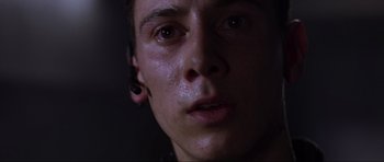 Movie still from “Doom” (2005), directed by Andrzej Bartkowiak – A person's face with ear buds in their ears; Close Up shot, Low angle