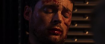 Movie still from “Doom” (2005), directed by Andrzej Bartkowiak – A person with blood all over his face; Extreme Close Up shot, Overhead angle