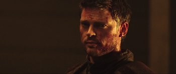 Movie still from “Doom” (2005), directed by Andrzej Bartkowiak – A person with blood all over his face; Close Up shot, Over the shoulder angle