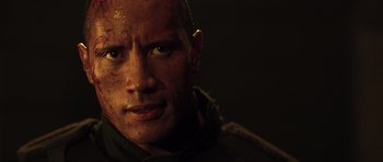 Movie still from “Doom” (2005), directed by Andrzej Bartkowiak – A person with a face covered in dirt; Close Up shot, Low angle