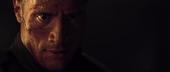 Movie still from “Doom” (2005), directed by Andrzej Bartkowiak – A man's face in the dark; Close Up shot, Low angle