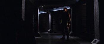 Movie still from “Doom” (2005), directed by Andrzej Bartkowiak – A man standing in the dark in a building; Wide shot, Low angle