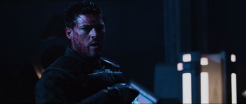 Movie still from “Doom” (2005), directed by Andrzej Bartkowiak – A person holding a gun in a dark room; Close Up shot, Over the shoulder angle