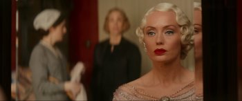 Movie still from “Downton Abbey: A New Era” (2022), directed by Simon Curtis – A woman with red lipstick standing in front of another woman; Close Up shot, Over the shoulder angle
