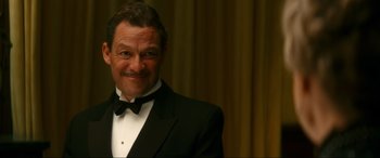 Movie still from “Downton Abbey: A New Era” (2022), directed by Simon Curtis – A man in a tuxedo smiling for the camera; Close Up shot, Low angle