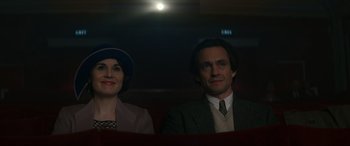 Movie still from “Downton Abbey: A New Era” (2022), directed by Simon Curtis – A man and a woman sitting next to each other; Medium shot, Low angle
