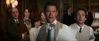 Movie still from “Downton Abbey: A New Era” (2022), directed by Simon Curtis – A man in a suit and tie holding a flask; Close Up shot, Low angle