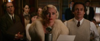 Movie still from “Downton Abbey: A New Era” (2022), directed by Simon Curtis – A woman with blonde hair wearing a white fur coat; Medium shot, Low angle