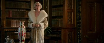 Movie still from “Downton Abbey: A New Era” (2022), directed by Simon Curtis – A woman in a white dress and a white fur coat; Medium shot, Low angle