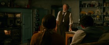 Movie still from “Downton Abbey: A New Era” (2022), directed by Simon Curtis – An old man standing in front of a young girl; Medium shot, Over the shoulder angle