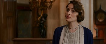 Movie still from “Downton Abbey: A New Era” (2022), directed by Simon Curtis – A woman in a white blouse and a blue jacket; Close Up shot, Over the shoulder angle