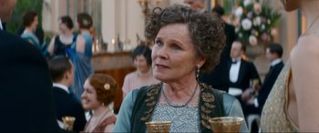 Movie still from “Downton Abbey: A New Era” (2022), directed by Simon Curtis – An older woman is looking to her left; Close Up shot, Over the shoulder angle