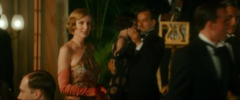 Movie still from “Downton Abbey: A New Era” (2022), directed by Simon Curtis – A woman standing next to a man in a tuxedo; Medium shot, Over the shoulder angle