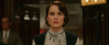 Movie still from “Downton Abbey: A New Era” (2022), directed by Simon Curtis – A person wearing a necklace; Close Up shot, Low angle
