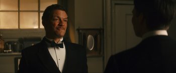 Movie still from “Downton Abbey: A New Era” (2022), directed by Simon Curtis – A man in a tuxedo standing in front of a mirror; Close Up shot, Low angle
