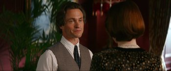 Movie still from “Downton Abbey: A New Era” (2022), directed by Simon Curtis – A man in a vest and tie standing next to a woman; Close Up shot, Over the shoulder angle