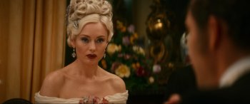 Movie still from “Downton Abbey: A New Era” (2022), directed by Simon Curtis – A woman in a white dress with a flower in her hair; Close Up shot, Over the shoulder angle