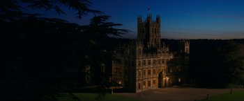 Movie still from “Downton Abbey: A New Era” (2022), directed by Simon Curtis – A large building in the middle of the night time; Extreme Wide shot, High angle