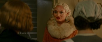 Movie still from “Downton Abbey: A New Era” (2022), directed by Simon Curtis – A woman with blonde hair wearing a fur coat; Close Up shot, Over the shoulder angle