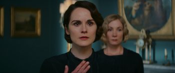 Movie still from “Downton Abbey: A New Era” (2022), directed by Simon Curtis – Two women standing next to each other in front of a mirror; Close Up shot, Over the shoulder angle