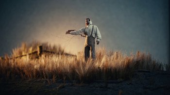 Movie still from “Euphoria” (2019), created by Sam Levinson – A man standing in the middle of a dry grass field; Extreme Wide shot, Low angle