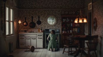Movie still from “Euphoria” (2019), created by Sam Levinson – A woman kneeling down in a kitchen looking into an oven; Wide shot, High angle