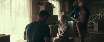 Movie still from “12 Strong” (2018), directed by Nicolai Fuglsig – A man and a little girl sitting in a room; Medium shot, Over the shoulder angle