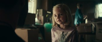 Movie still from “12 Strong” (2018), directed by Nicolai Fuglsig – A little girl with blonde hair and a pink shirt; Close Up shot, Over the shoulder angle