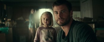 Movie still from “12 Strong” (2018), directed by Nicolai Fuglsig – A man and a little girl standing next to each other; Medium shot, Over the shoulder angle