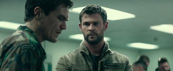 Movie still from “12 Strong” (2018), directed by Nicolai Fuglsig – Two men standing next to each other in a room; Close Up shot, Over the shoulder angle