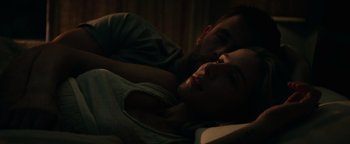 Movie still from “12 Strong” (2018), directed by Nicolai Fuglsig – A man and a woman laying in a bed together; Close Up shot, Low angle