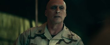 Movie still from “12 Strong” (2018), directed by Nicolai Fuglsig – A man in a military uniform is looking at the camera; Close Up shot, Low angle