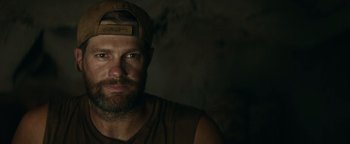 Movie still from “12 Strong” (2018), directed by Nicolai Fuglsig – A person wearing a hat; Close Up shot, Over the shoulder angle