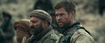 Movie still from “12 Strong” (2018), directed by Nicolai Fuglsig – Two bearded men are standing next to each other; Close Up shot, Over the shoulder angle