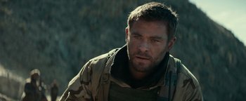 Movie still from “12 Strong” (2018), directed by Nicolai Fuglsig – A person wearing a jacket; Close Up shot, Over the shoulder angle