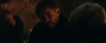 Movie still from “12 Strong” (2018), directed by Nicolai Fuglsig – A person wearing a black shirt; Close Up shot, Over the shoulder angle