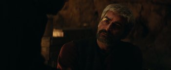 Movie still from “12 Strong” (2018), directed by Nicolai Fuglsig – A person sitting in a chair; Close Up shot, Over the shoulder angle