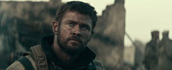 Movie still from “12 Strong” (2018), directed by Nicolai Fuglsig – A person wearing a jacket; Close Up shot, Over the shoulder angle