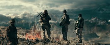 Movie still from “12 Strong” (2018), directed by Nicolai Fuglsig – A group of soldiers standing on top of a mountain; Wide shot, Low angle