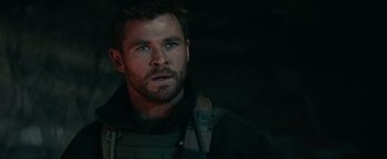 Movie still from “12 Strong” (2018), directed by Nicolai Fuglsig – A person wearing a vest; Close Up shot, Over the shoulder angle