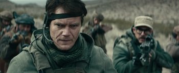 Movie still from “12 Strong” (2018), directed by Nicolai Fuglsig – Willem dafoe wearing a headband; Close Up shot, Over the shoulder angle