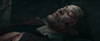 Movie still from “12 Strong” (2018), directed by Nicolai Fuglsig – A man with blood all over his face and chest; Close Up shot, Overhead angle