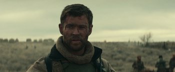 Movie still from “12 Strong” (2018), directed by Nicolai Fuglsig – A person wearing a scarf; Close Up shot, Over the shoulder angle