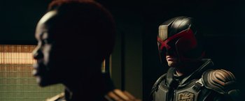 Movie still from “Dredd” (2012), directed by Pete Travis – A man wearing a helmet looking into a mirror; Close Up shot, Over the shoulder angle