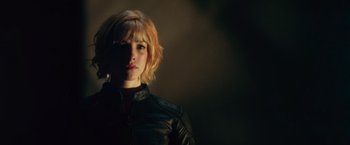 Movie still from “Dredd” (2012), directed by Pete Travis – A woman with blonde hair wearing a leather jacket; Close Up shot, Low angle