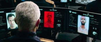 Movie still from “Dredd” (2012), directed by Pete Travis – An older man sitting in front of a computer screen; Close Up shot, Over the shoulder angle